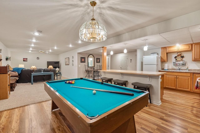 1300 Hidden Fields Dr, West Bend, WI 53095 - rec room featuring light wood-style flooring, billiards table, and a chandelier
