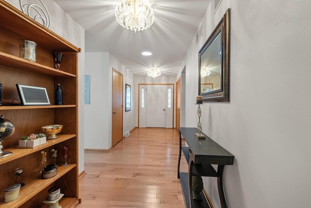 1300 Hidden Fields Dr, West Bend, WI 53095 - foyer featuring light wood finished floors and a chandelier