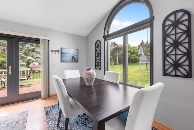 1300 Hidden Fields Dr, West Bend, WI 53095 - dining space with vaulted ceiling and light wood-style flooring