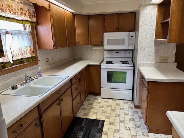420 Jackson St, Waupun, WI 53963 - kitchen featuring white appliances, a sink, light floors, and light countertops