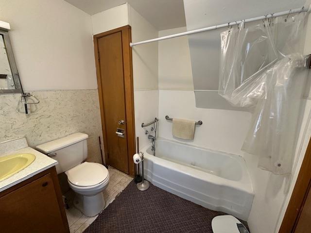420 Jackson St, Waupun, WI 53963 - bathroom with toilet, vanity, shower / bath combo, and tile patterned floors