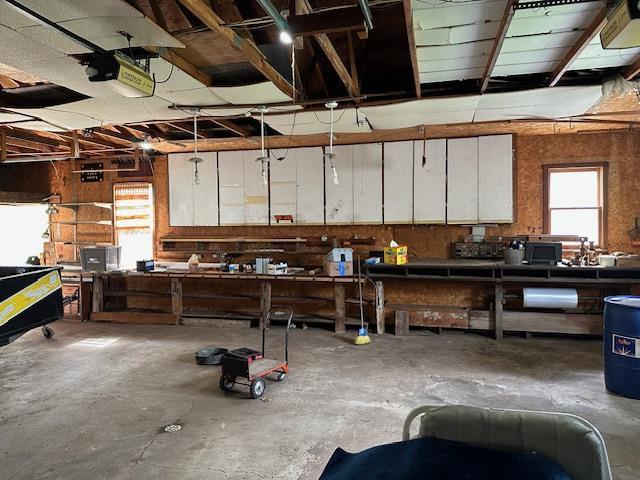 420 Jackson St, Waupun, WI 53963 - garage with a workshop area and a garage door opener