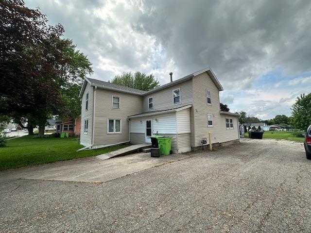 420 Jackson St, Waupun, WI 53963 - rear view of property featuring a lawn and driveway