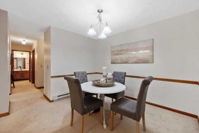 530 N Silverbrook Dr Unit 121, West Bend, WI 53090 - dining room with baseboard heating, light carpet, and a chandelier