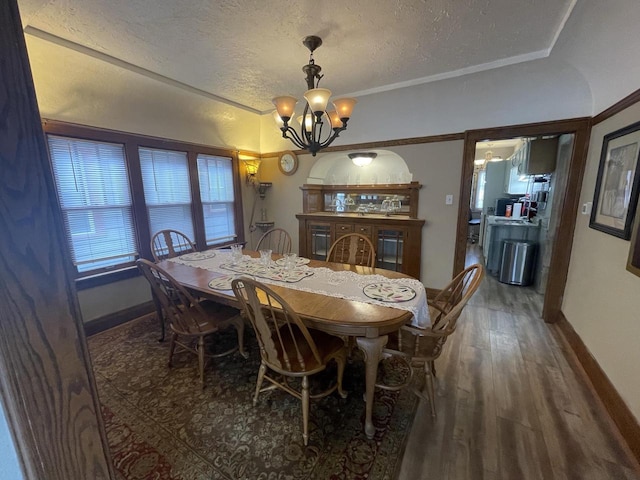 3915 N 23rd St, Milwaukee, WI 53206 - dining area featuring a chandelier, a textured ceiling, and wood finished floors
