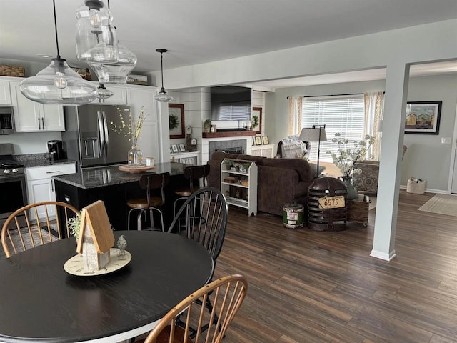 342 E Chapel Royal Dr, Verona, WI 53593 - dining area featuring dark wood-style flooring and a fireplace