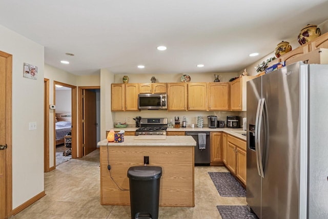 34116 Valley Dr, Burlington, WI 53105 - kitchen featuring appliances with stainless steel finishes, light countertops, light brown cabinetry, a center island, and recessed lighting