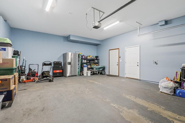 34116 Valley Dr, Burlington, WI 53105 - garage featuring a garage door opener and stainless steel refrigerator with ice dispenser