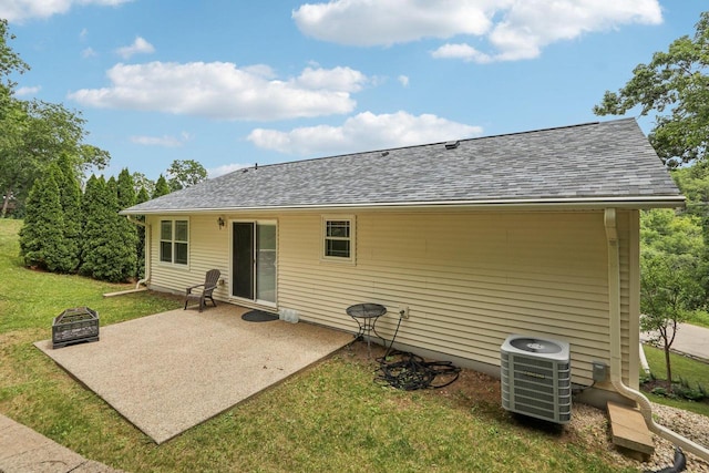 34116 Valley Dr, Burlington, WI 53105 - back of property featuring a patio, a lawn, a shingled roof, and a fire pit