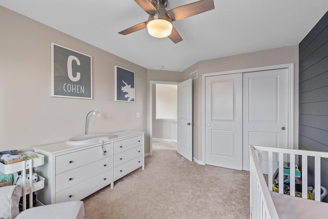 6028 Star Grass Ln, Racine, WI 53406 - bedroom with light colored carpet, a closet, and ceiling fan