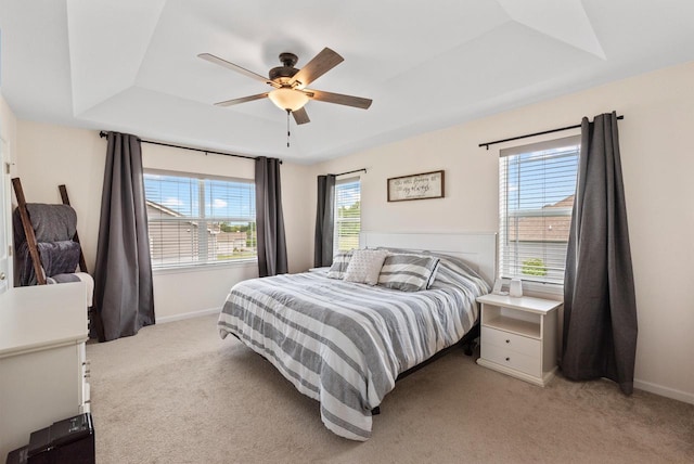 6028 Star Grass Ln, Racine, WI 53406 - bedroom featuring light carpet, a tray ceiling, and a ceiling fan