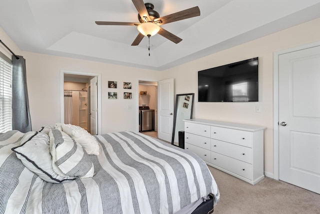6028 Star Grass Ln, Racine, WI 53406 - bedroom with a raised ceiling, light colored carpet, washer / dryer, ceiling fan, and connected bathroom