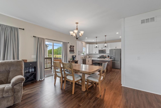 6028 Star Grass Ln, Racine, WI 53406 - dining area with dark wood-style flooring, a chandelier, and recessed lighting