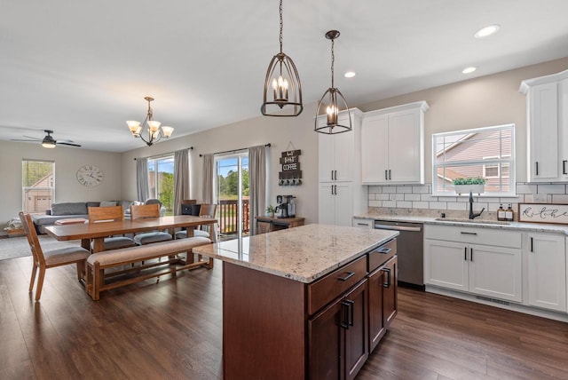 6028 Star Grass Ln, Racine, WI 53406 - kitchen with stainless steel dishwasher, a chandelier, recessed lighting, decorative backsplash, and hanging light fixtures