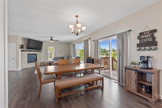 6028 Star Grass Ln, Racine, WI 53406 - dining space with plenty of natural light, a chandelier, a fireplace, and dark wood finished floors