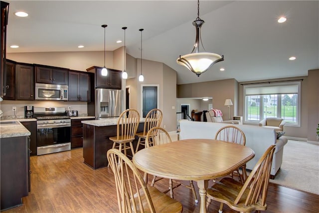 964 S Kelly Rd, Ellsworth, WI 54011 - dining space with lofted ceiling and light wood-style flooring