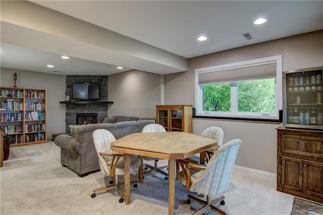 964 S Kelly Rd, Ellsworth, WI 54011 - carpeted dining space with a stone fireplace and recessed lighting