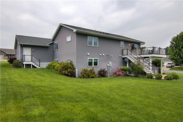 964 S Kelly Rd, Ellsworth, WI 54011 - back of property with stairway, a lawn, and a deck