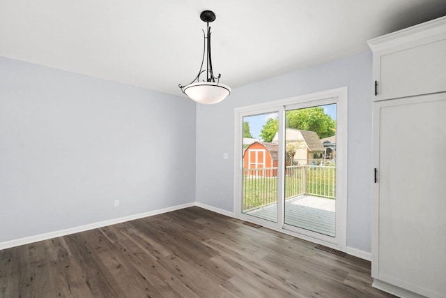 2711 Hyacinth Ave, Janesville, WI 53545 - unfurnished dining area with wood finished floors and baseboards
