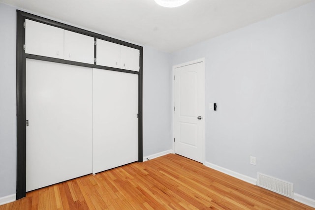 2711 Hyacinth Ave, Janesville, WI 53545 - unfurnished bedroom featuring light wood-style flooring and a closet