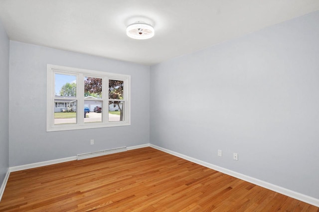 2711 Hyacinth Ave, Janesville, WI 53545 - empty room with baseboard heating and light wood-type flooring