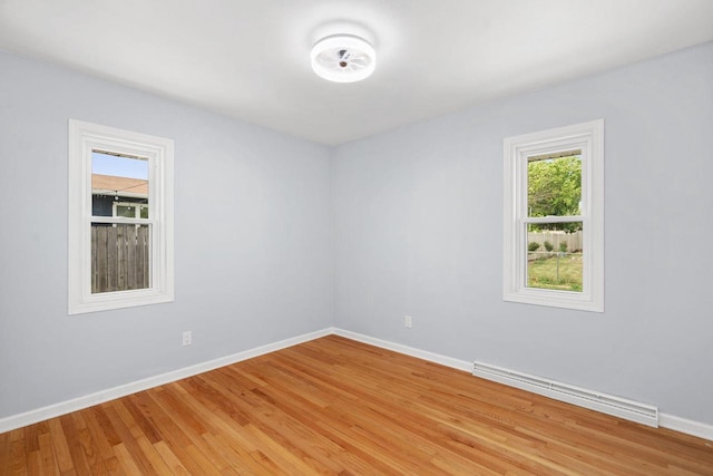 2711 Hyacinth Ave, Janesville, WI 53545 - spare room with a baseboard heating unit and light wood finished floors