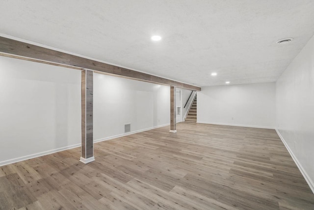 2711 Hyacinth Ave, Janesville, WI 53545 - finished basement featuring stairway, recessed lighting, and wood finished floors