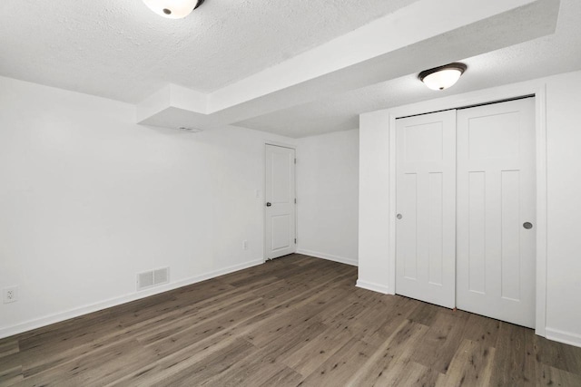 2711 Hyacinth Ave, Janesville, WI 53545 - unfurnished bedroom featuring wood finished floors, a textured ceiling, and a closet