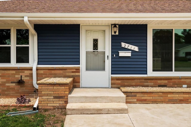2711 Hyacinth Ave, Janesville, WI 53545 - property entrance with a shingled roof