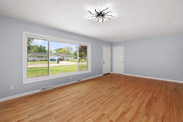 2711 Hyacinth Ave, Janesville, WI 53545 - unfurnished living room featuring light wood finished floors and baseboards