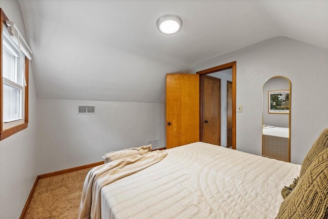 7838 N Sherman Blvd, Brown Deer, WI 53209 - carpeted bedroom with lofted ceiling and baseboards