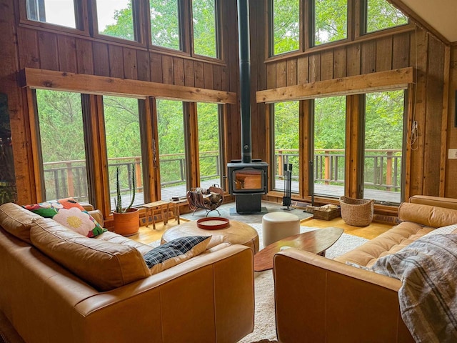 5362 Mahocker Rd, Mazomanie, WI 53560 - living room with a wood stove, a towering ceiling, and wooden walls