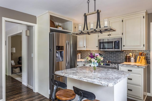 11 Meadowbrook Ct, Appleton, WI 54914 - kitchen with stainless steel appliances, decorative backsplash, dark wood finished floors, and a center island