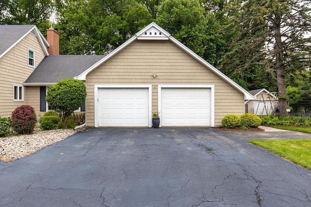 11 Meadowbrook Ct, Appleton, WI 54914 - view of front of home with asphalt driveway, a chimney, and a shingled roof