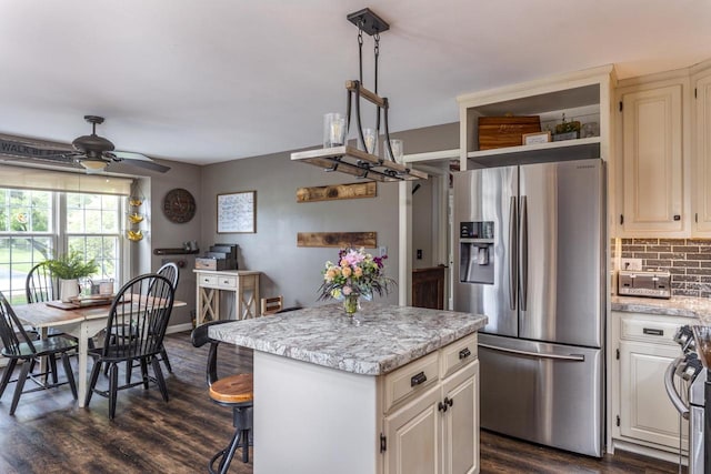 11 Meadowbrook Ct, Appleton, WI 54914 - kitchen with appliances with stainless steel finishes, a center island, decorative backsplash, ceiling fan, and dark wood-style flooring