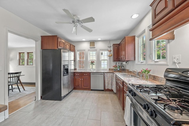 6223 W Wisconsin Ave, Wauwatosa, WI 53213 - kitchen featuring appliances with stainless steel finishes, light stone countertops, a ceiling fan, light wood finished floors, and recessed lighting