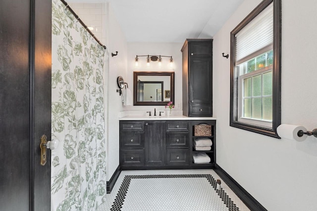 6223 W Wisconsin Ave, Wauwatosa, WI 53213 - full bath with vanity, curtained shower, and tile patterned floors