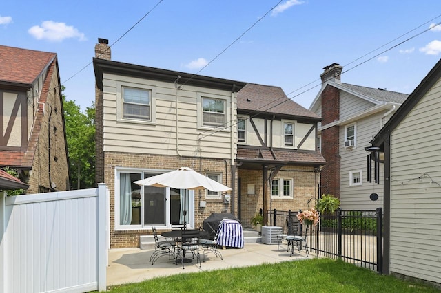6223 W Wisconsin Ave, Wauwatosa, WI 53213 - back of house with brick siding and a patio