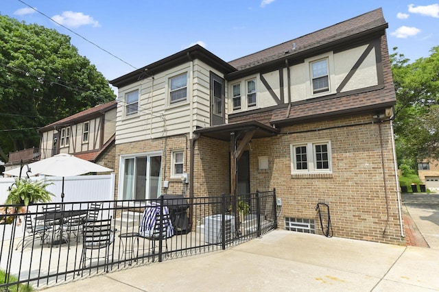 6223 W Wisconsin Ave, Wauwatosa, WI 53213 - rear view of property featuring a patio area and brick siding