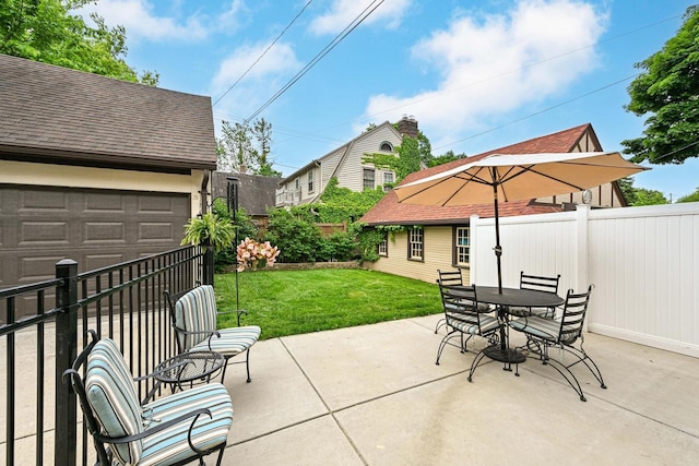 6223 W Wisconsin Ave, Wauwatosa, WI 53213 - fenced backyard featuring a garage, a patio area, and outdoor dining space