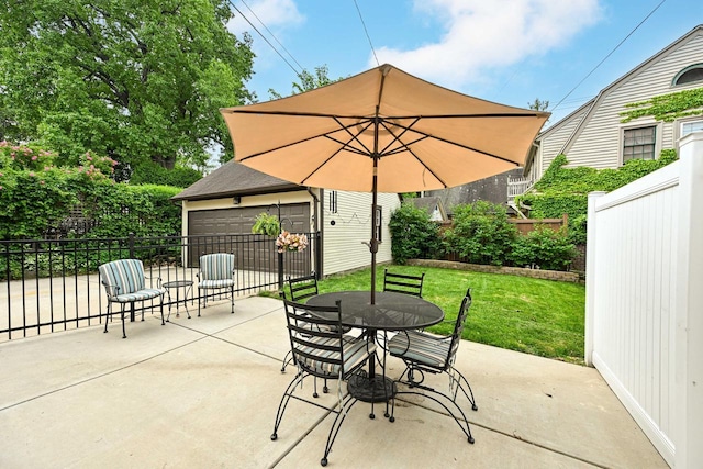 6223 W Wisconsin Ave, Wauwatosa, WI 53213 - fenced backyard featuring a detached garage, a patio area, an outbuilding, and outdoor dining area