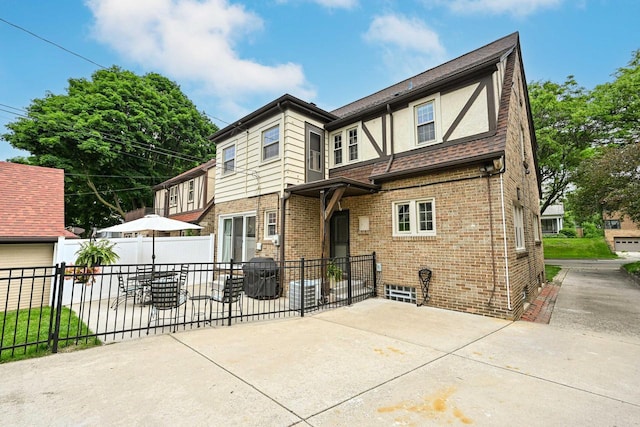 6223 W Wisconsin Ave, Wauwatosa, WI 53213 - rear view of house with a patio area, brick siding, and stucco siding