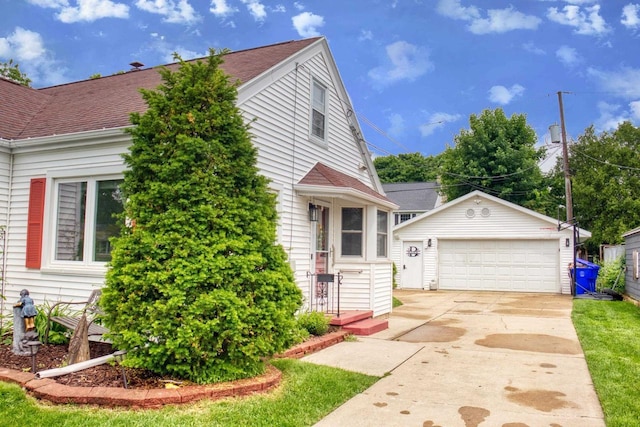 1702 S Douglas St, Appleton, WI 54914 - view of front facade featuring an outdoor structure, a garage, and a shingled roof