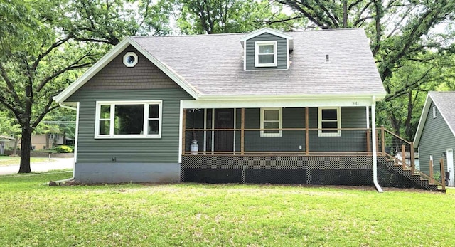 341 Grove St, Lake Mills, WI 53551 - view of front of property with a front yard and a shingled roof