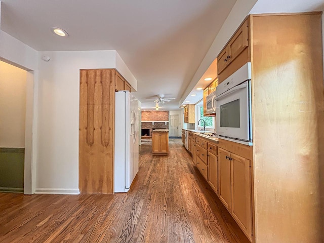 417 Anglesey Rd, Wales, WI 53183 - kitchen featuring white appliances, wood finished floors, a ceiling fan, a fireplace, and recessed lighting