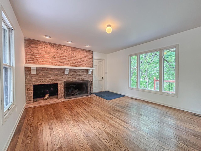 417 Anglesey Rd, Wales, WI 53183 - unfurnished living room featuring a fireplace and wood finished floors