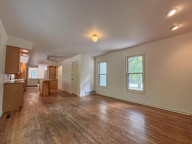 417 Anglesey Rd, Wales, WI 53183 - unfurnished living room with dark wood-type flooring and ceiling fan