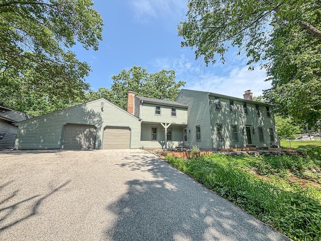 417 Anglesey Rd, Wales, WI 53183 - view of front of property featuring a chimney, asphalt driveway, and a garage