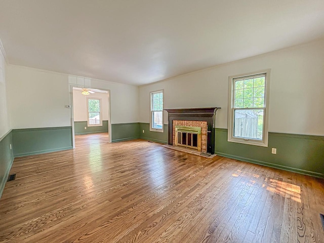 417 Anglesey Rd, Wales, WI 53183 - unfurnished living room featuring wood finished floors, crown molding, a fireplace, and ceiling fan