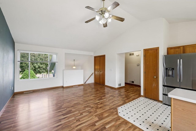609-611 Eagle Crest Ct, Prairie Du Sac, WI 53578 - kitchen featuring stainless steel fridge, light wood finished floors, ceiling fan, light countertops, and high vaulted ceiling
